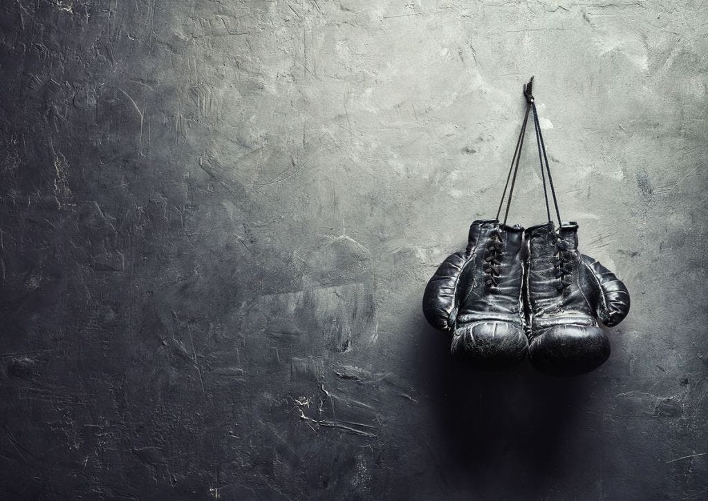 Picture of boxing fight gloves hanging on wall