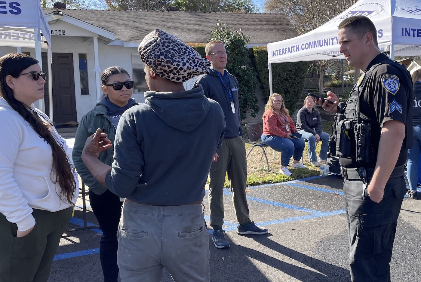 Greg Angela of Interfaith Community Services, second from right, and at least 10 other service providers were at the Church of God on Harmony Grove Road on Monday as the city cleared a homeless encampment due to a public health emergency. Steve Puterski photo