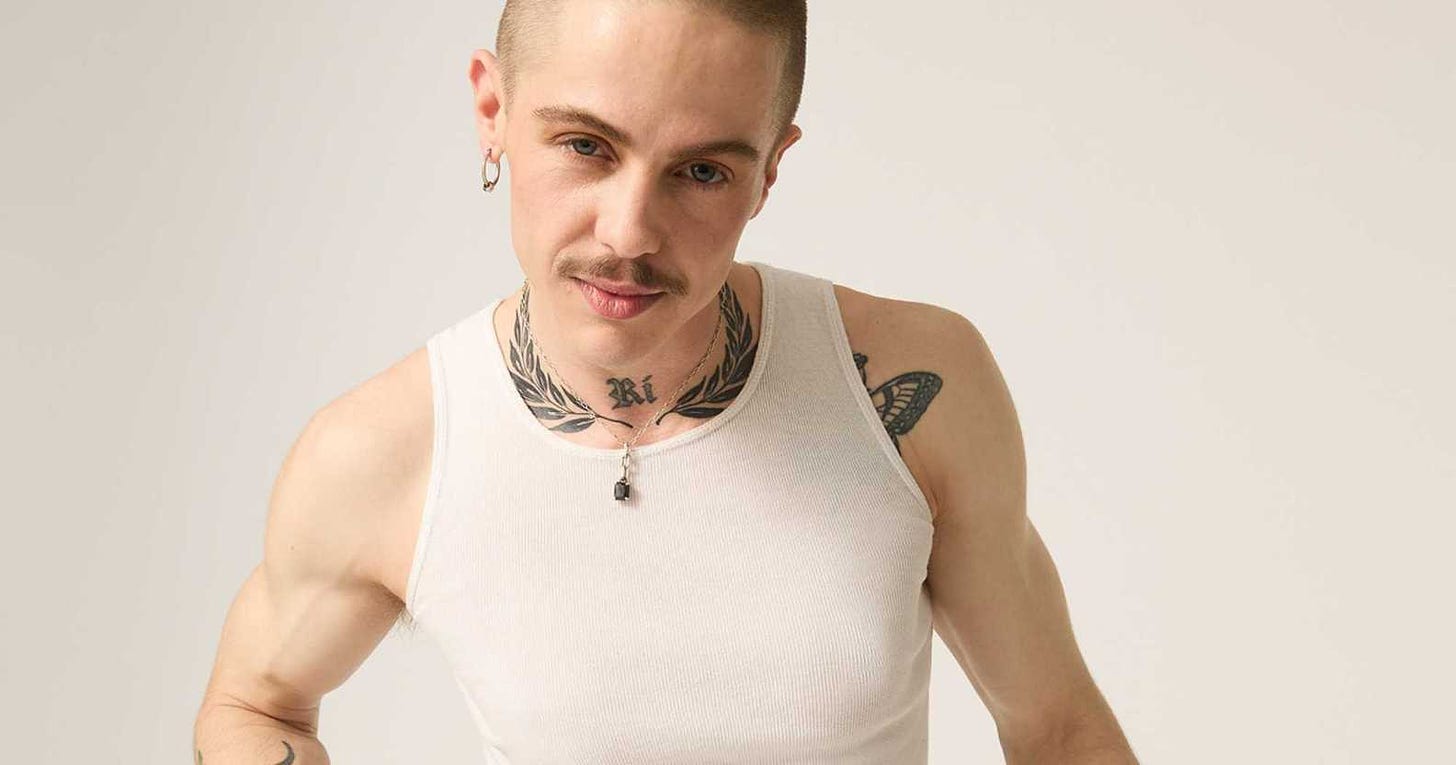 Model Oscar McGregor wearing a white vest top