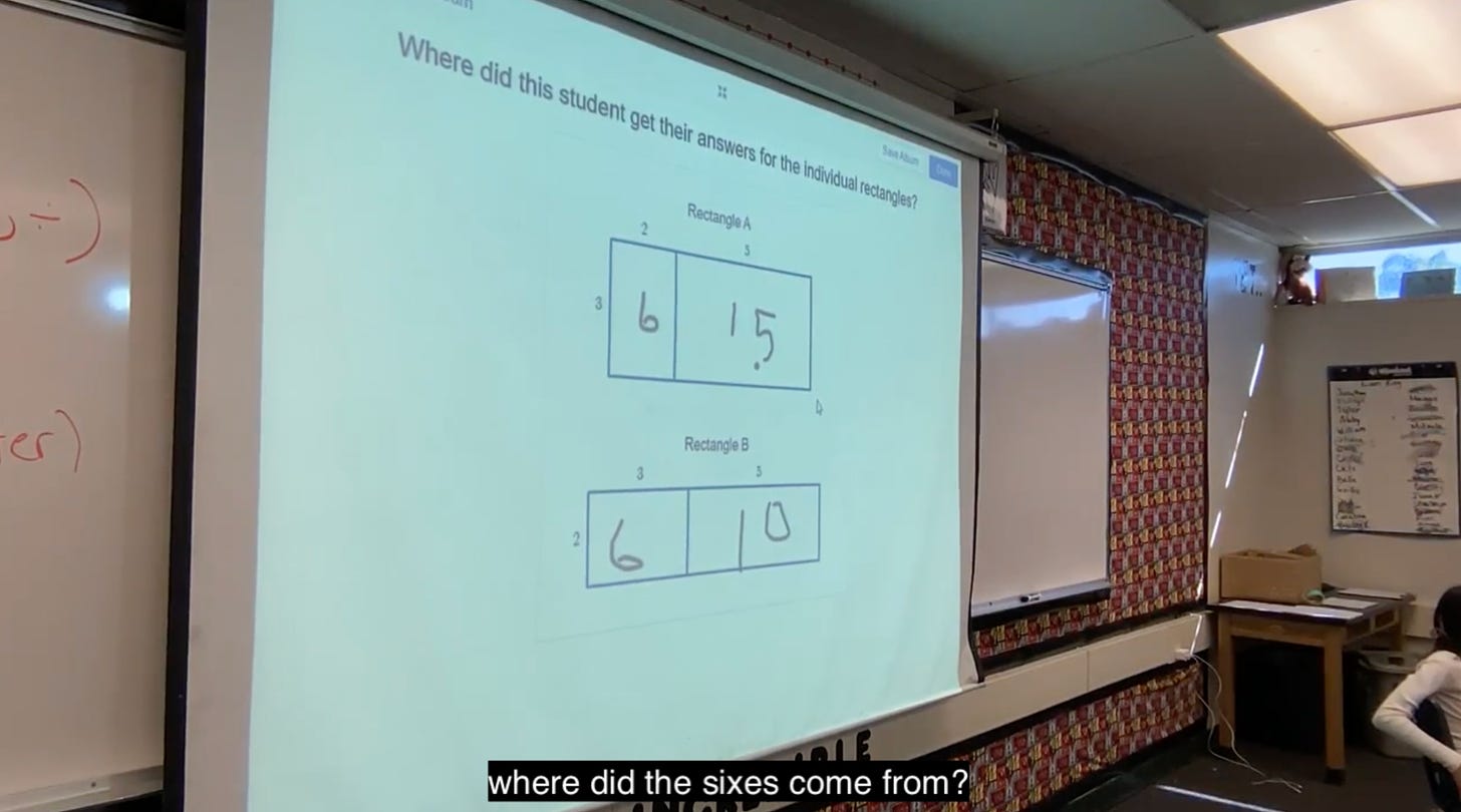 A video still - the projector screen shows student work and the question "Where did this student get their answers for the individual rectangles?"