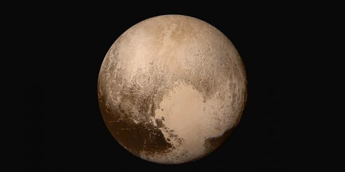 IN SPACE - JULY 14: In this handout provided by the National Aeronautics and Space Administration (NASA), Pluto nearly fills the frame in this image from the Long Range Reconnaissance Imager (LORRI) aboard NASA's New Horizons spacecraft, taken on July 13, 2015, when the spacecraft was 476,000 miles (768,000 kilometers) from the surface. This is the last and most detailed image sent to Earth before the spacecraft's closest approach to Pluto. New Horizons spacecraft is nearing its July 14 fly-by when it will close to a distance of about 7,800 miles (12,500 kilometers). The 1,050-pound piano sized probe, which was launched January 19, 2006 aboard an Atlas V rocket from Cape Canaveral, Florida, is traveling 30,800 mph as it approaches. (Photo by NASA/APL/SwRI via Getty Images)