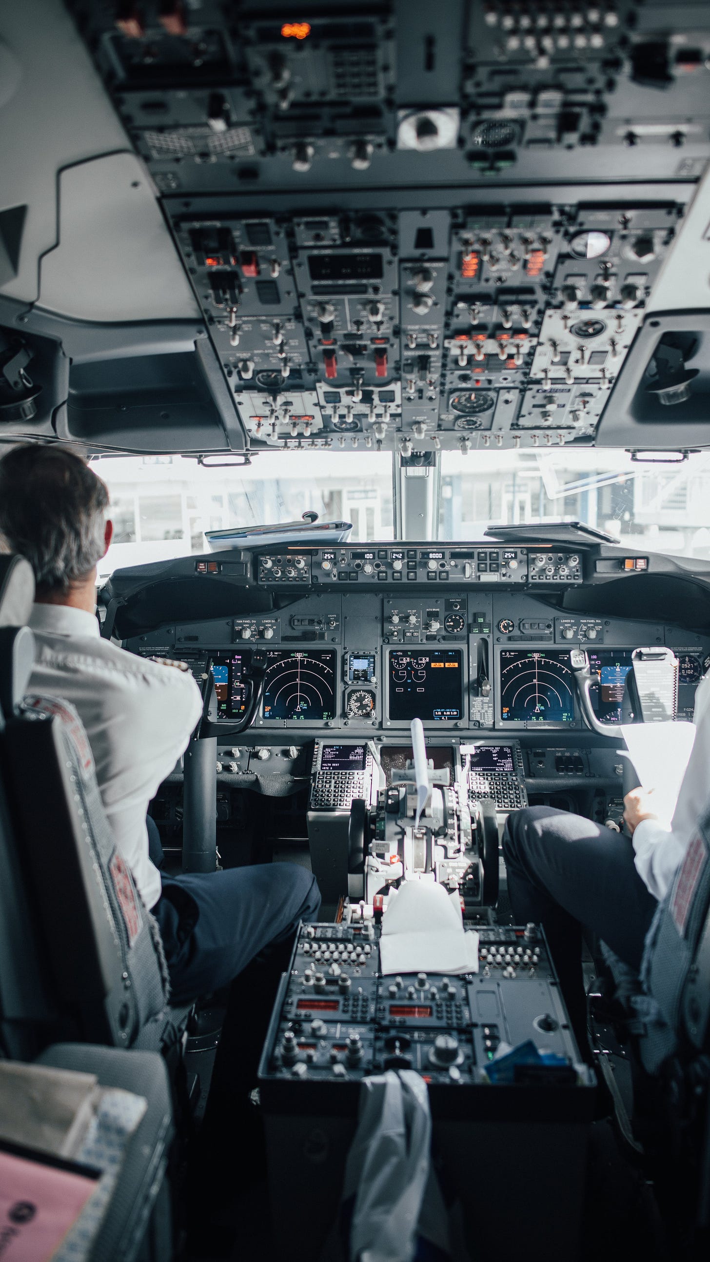 Free Man Sitting Inside a Cockpit of an Airplane Stock Photo
