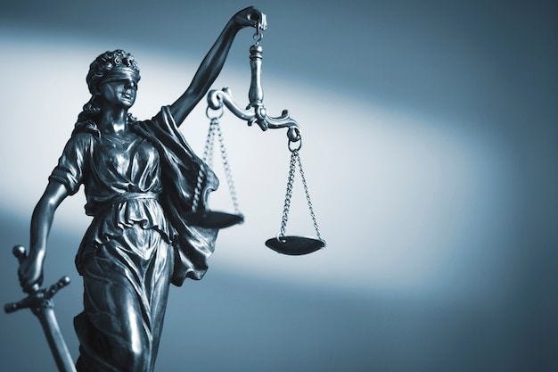 Photo figure of justice holding scales and a sword