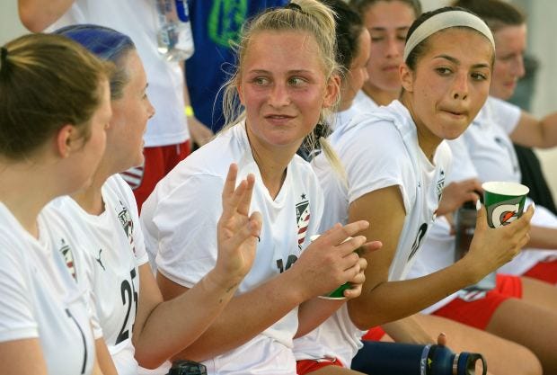 Team USA’s Ashley Derrington (25) and Sophie Post (12) communicate...