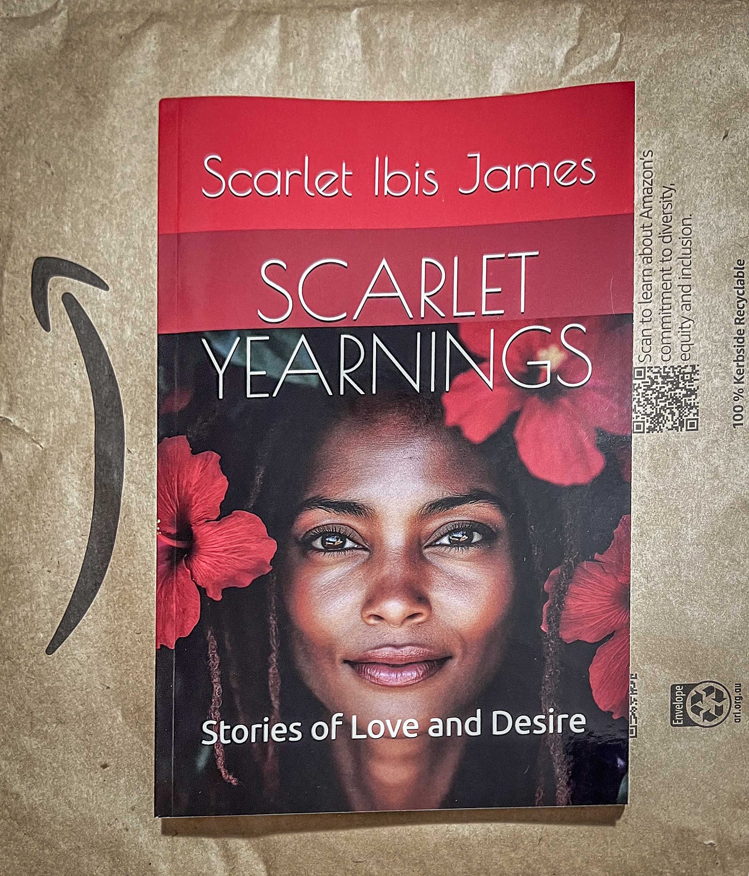 A beautiful young Black woman looks out of a backround of red hibiscus flowers in this cover image from my "Scarlet Yearnings" review.