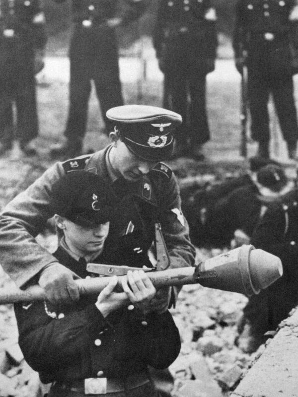 World War II History on X: "A German soldier teaches a member of the Hitler  Youth how to fire a Panzerfaust anti-tank weapon prior to the Battle of  Berlin, 1945. #History #WWII