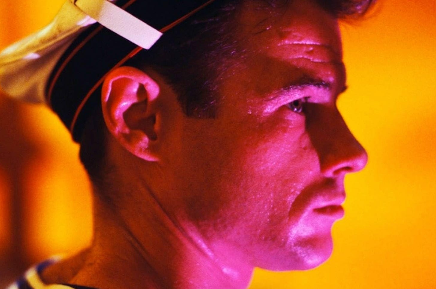 Brad Davis in pink profile in Fassbinder's "Querelle" (1982)