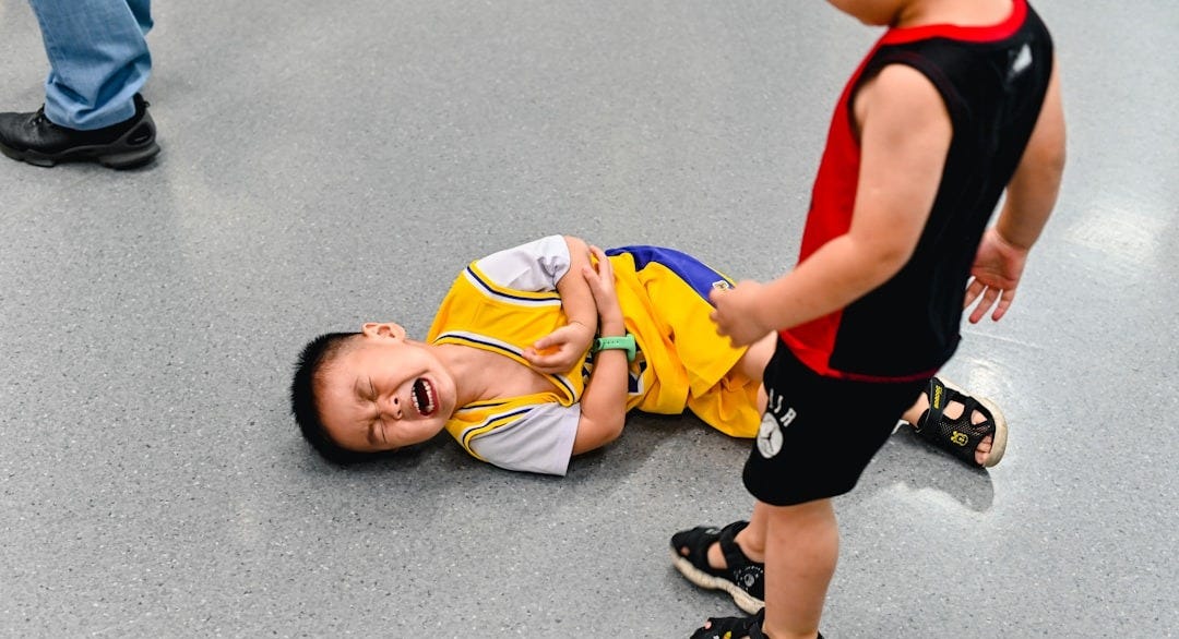 2 boys lying on the ground