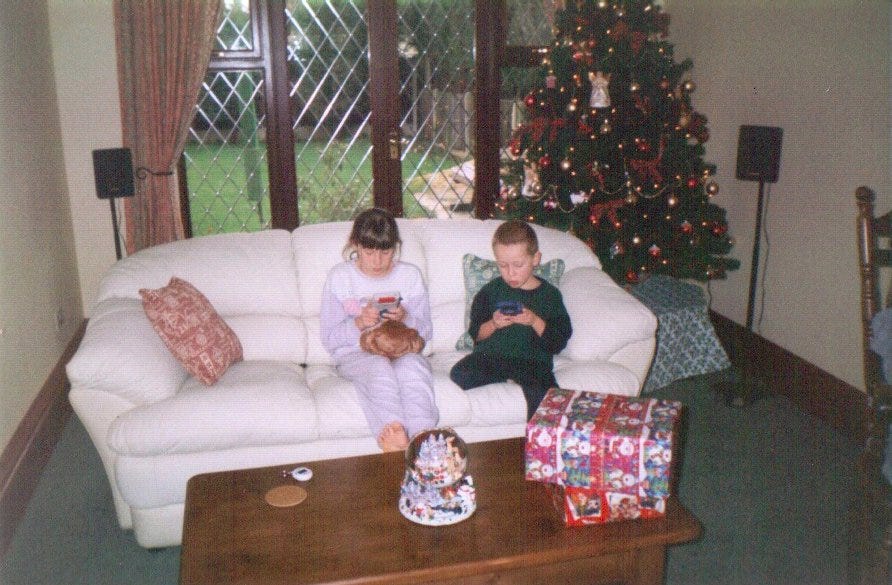 Rachael and her brother enjoying Pokémon Red and Blue on December 25th 1999