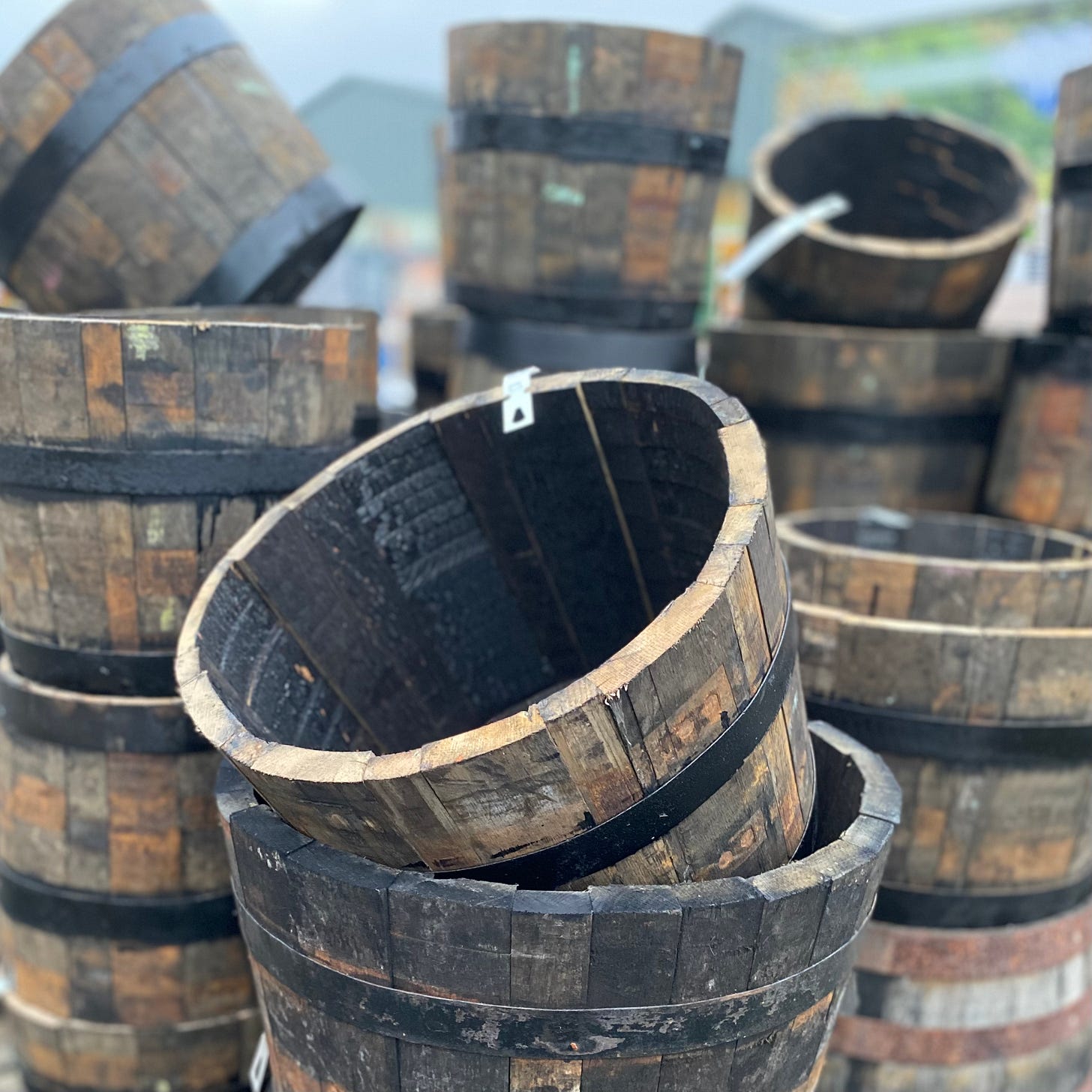 Stacks of wooden barrel planters piled high in a garden centre Stacks of wooden barrel planters piled high in a garden centre