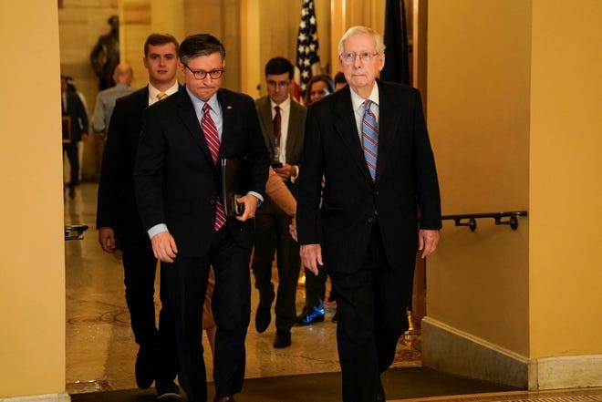 U.S. House Speaker Mike Johnson (R-LA) and U.S. Senate Minority Leader Mitch McConnell (R-KY) walk from McConnell's office to a lunch meeting at the U.S. Capitol in Washington, D.C. on November 29, 2023.