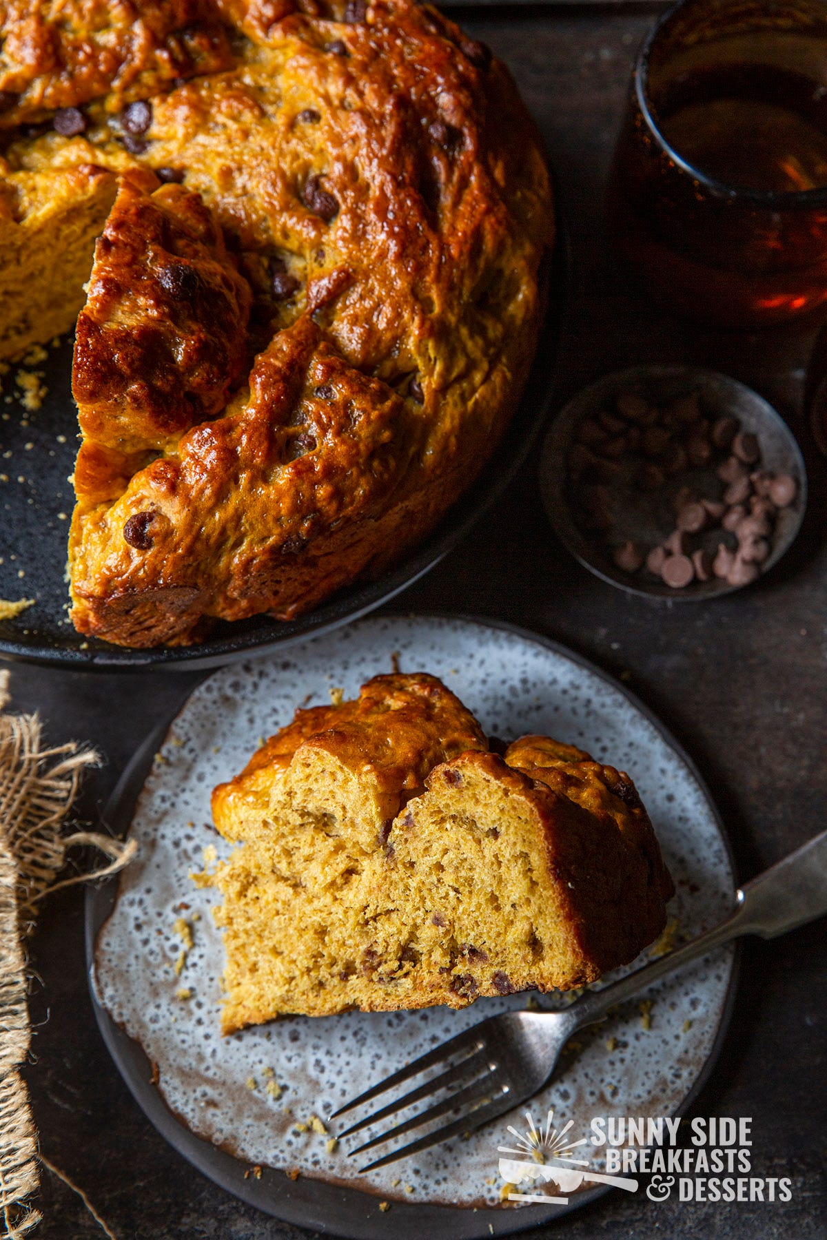 Braided pumpkin chocolate chip bread next to a slice of the bread.