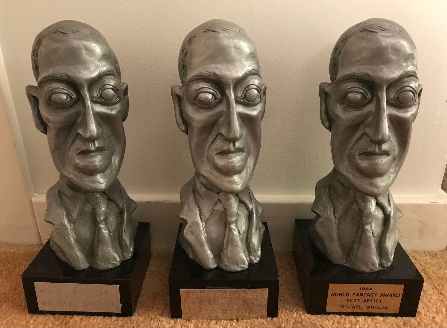 Three World Fantasy Awards featuring the bust of H.P. Lovecraft designed by Gahan Wilson