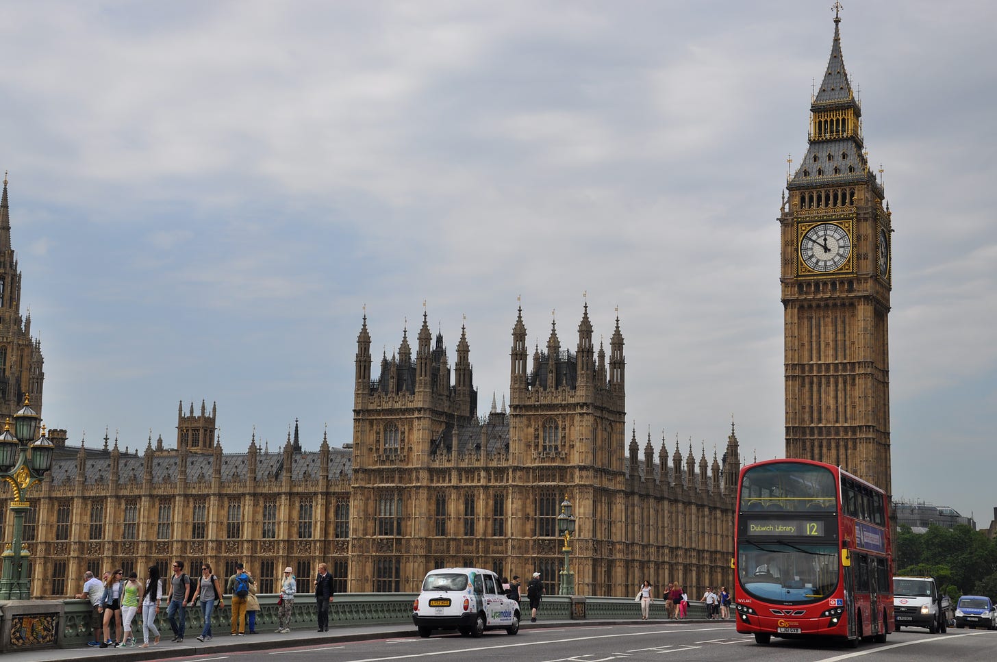 Parliament and Big Ben, a red double decker bus in front.