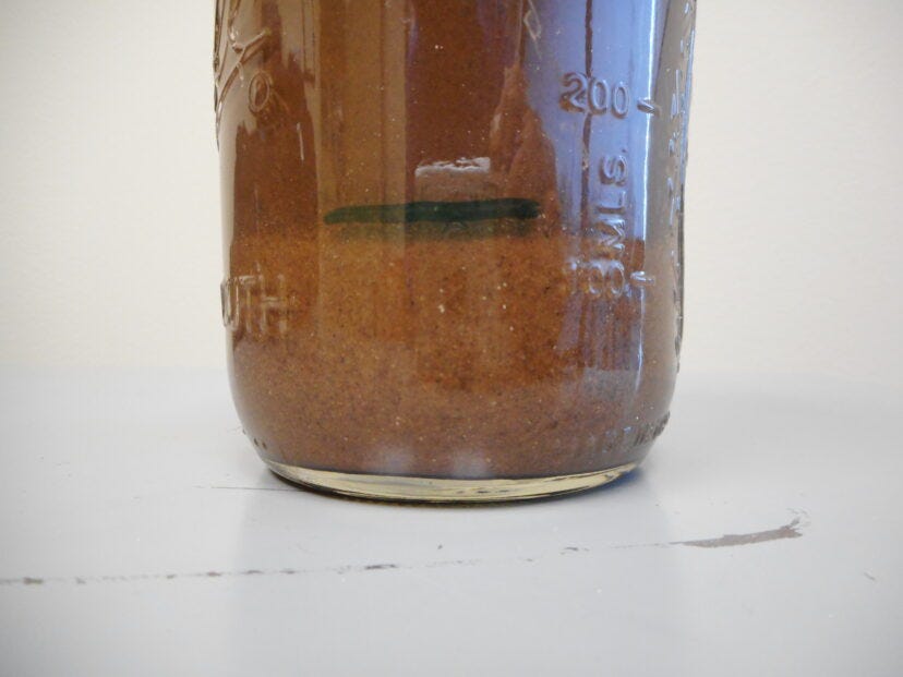 Jar showing the coarse sand layer settled at the bottom of the jar.