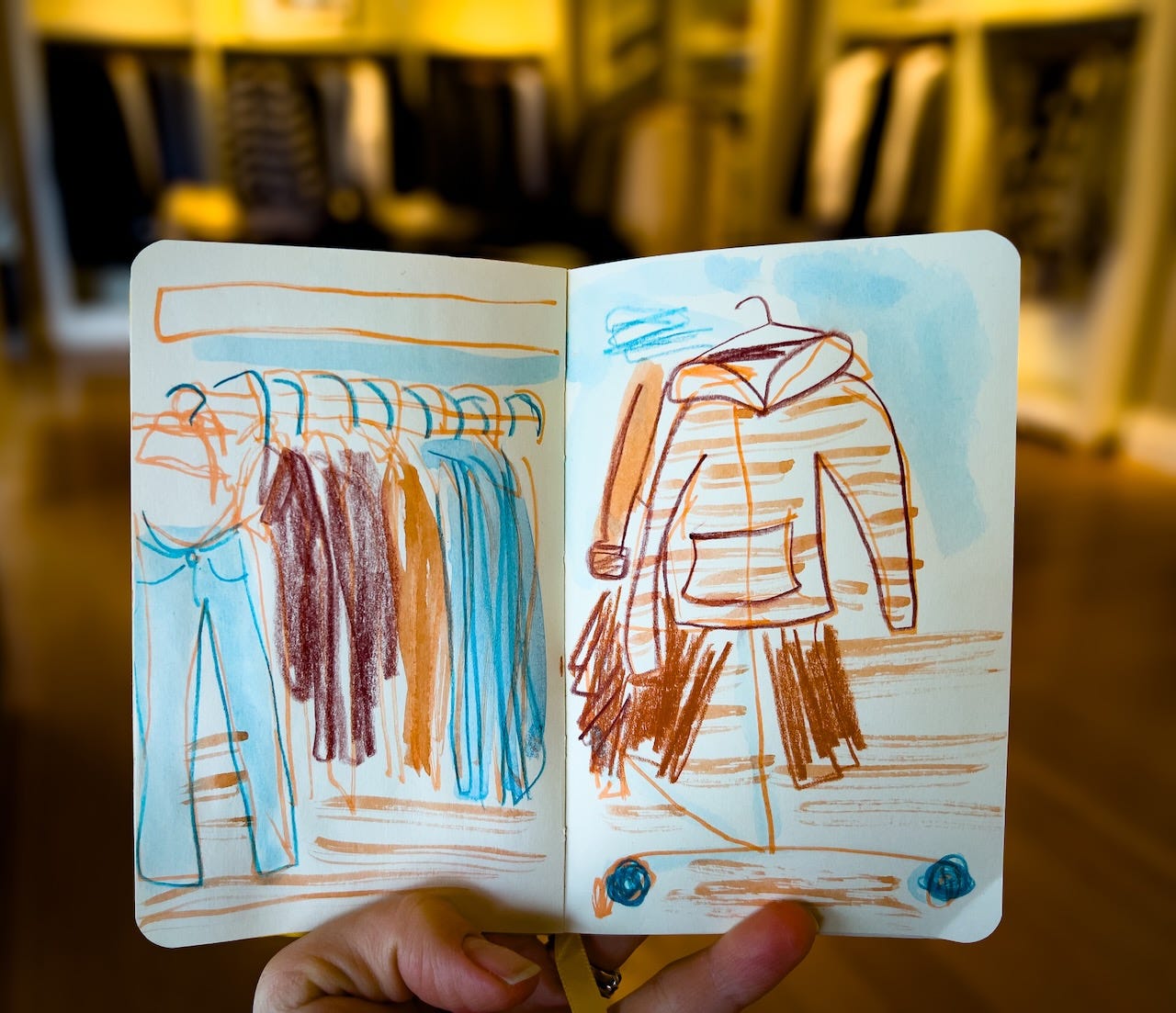 sketch of clothes hanging in a shop by Beth Spencer