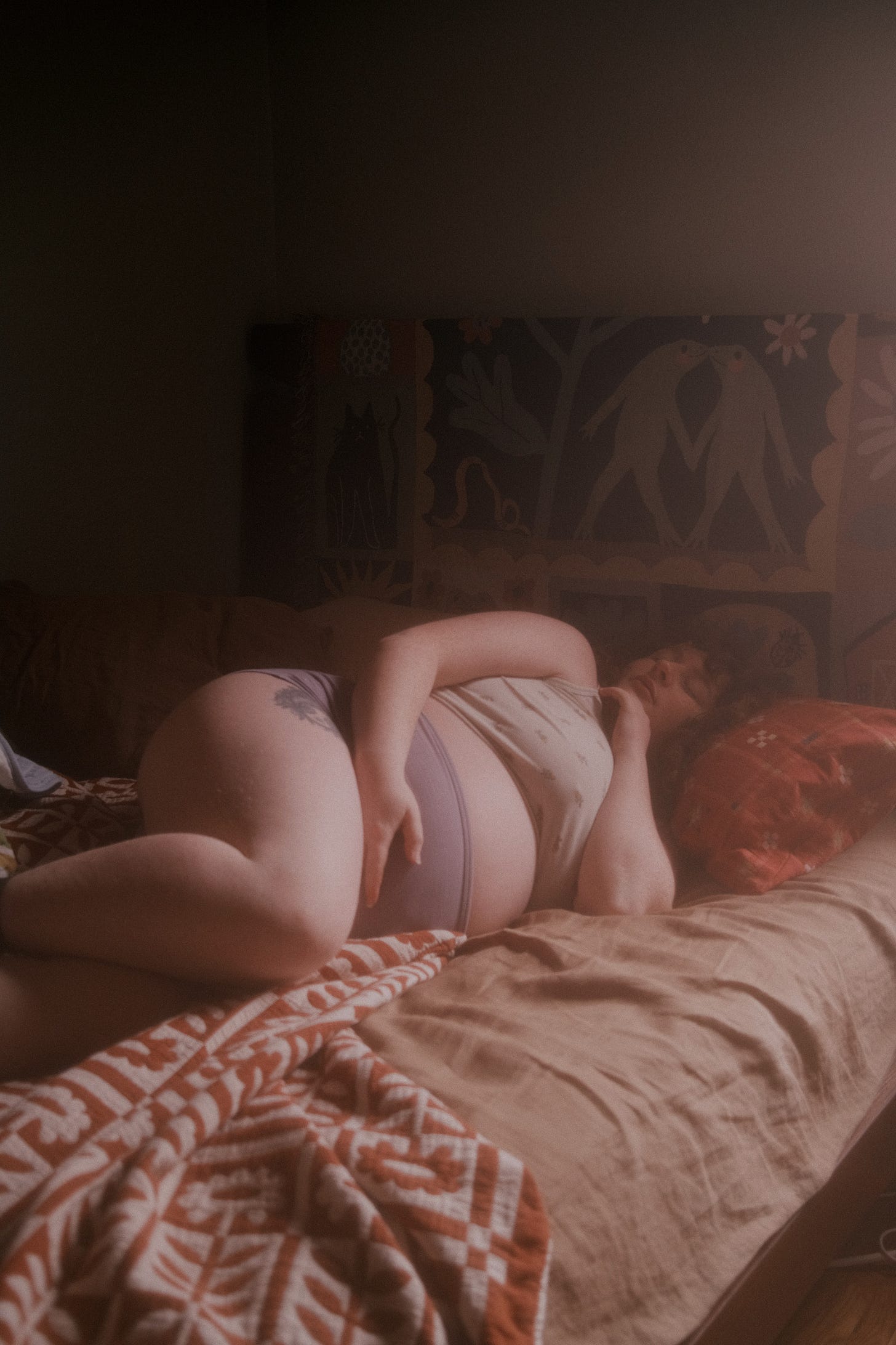 Me, pregnant laying in a bed