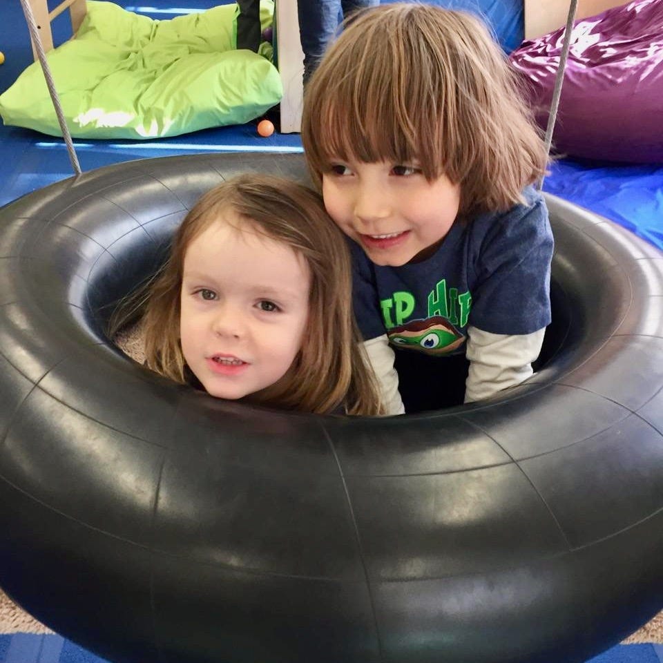 two best friends in a tire swing