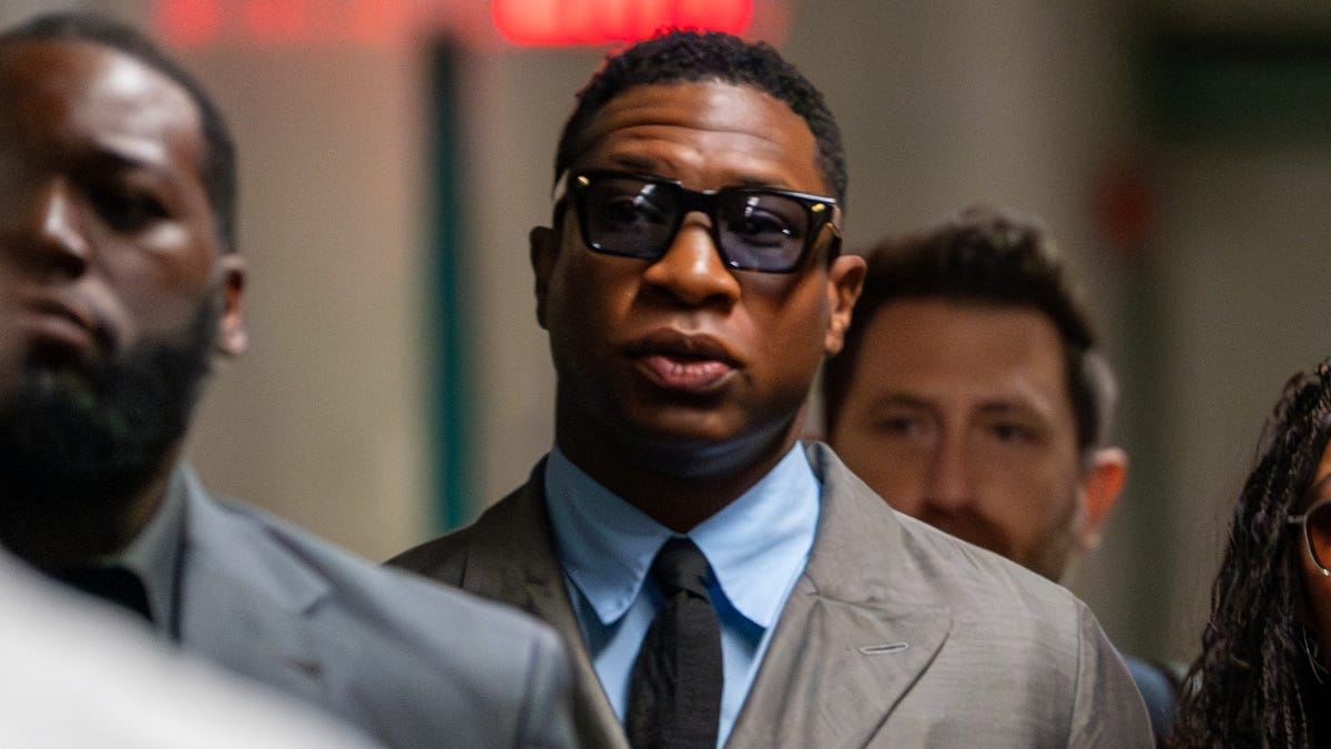 Actor Jonathan Majors, who faces assault and harassment charges, arrives in court with his partner, actor Meagan Good, in New York City on Aug. 3, 2023.