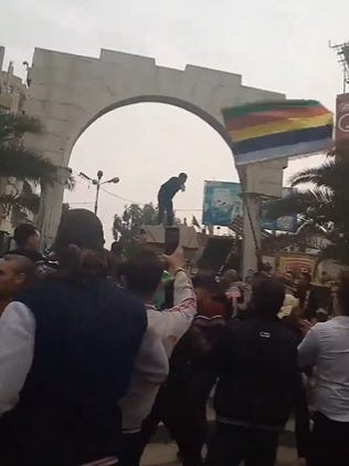 A man stands where the head of Hafez had been moments before