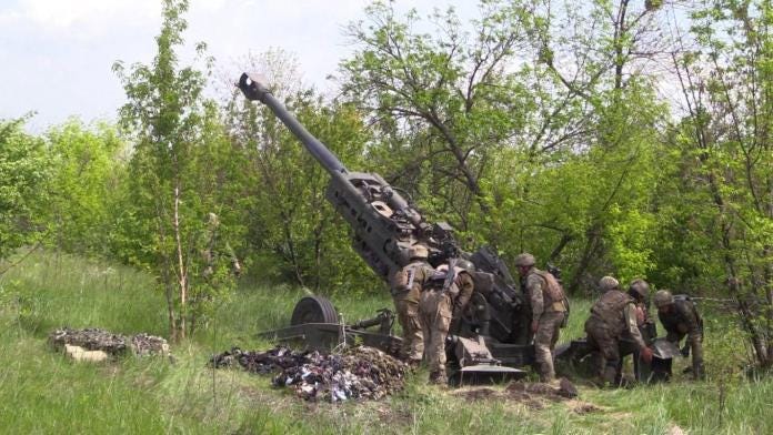 A group of soldiers standing next to a cannon

Description automatically generated