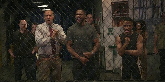 Walker Captain James and Trey rooting on Micki fighting in cage.