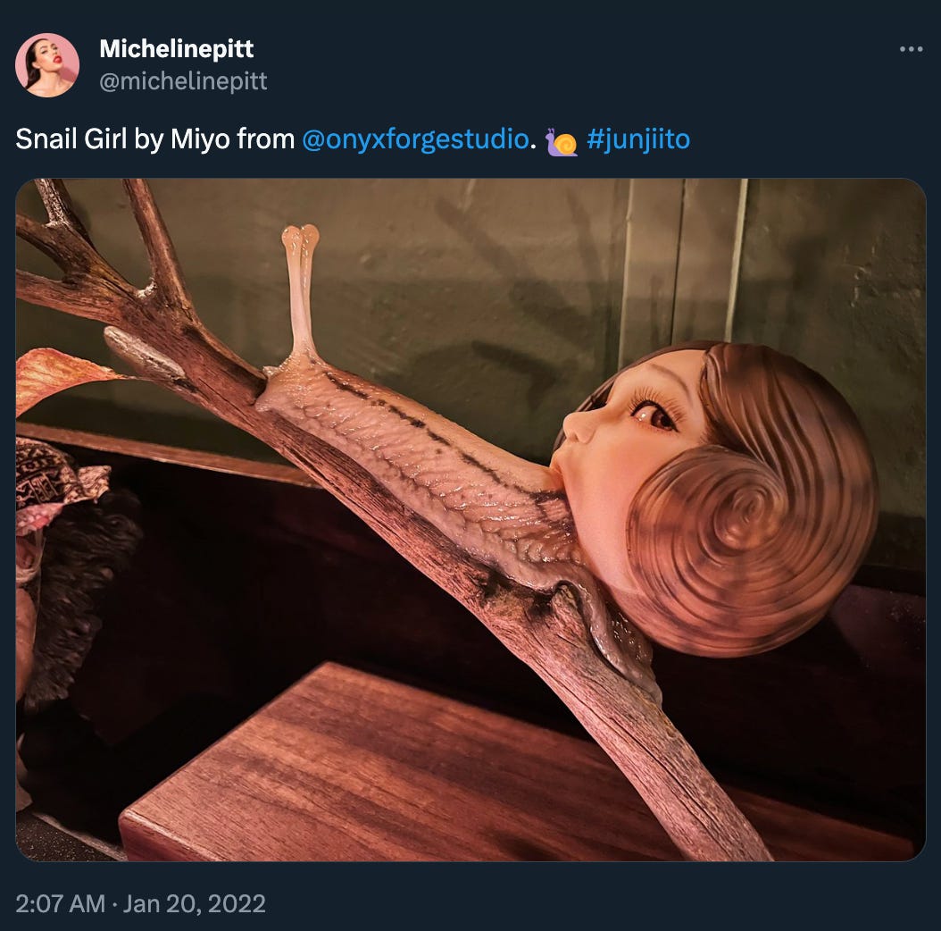 Micheline Pitt posted: “Snail Girl by Miyo from @onyxforgestudio 🐌 #junjiito” with a picture of a snail coming out of a shell painted to look like a girl’s face in profile. It’s uh, striking. 