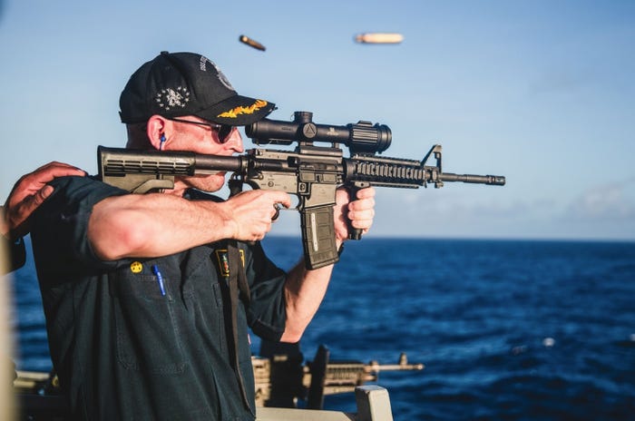US Navy firing gun with scope backwards