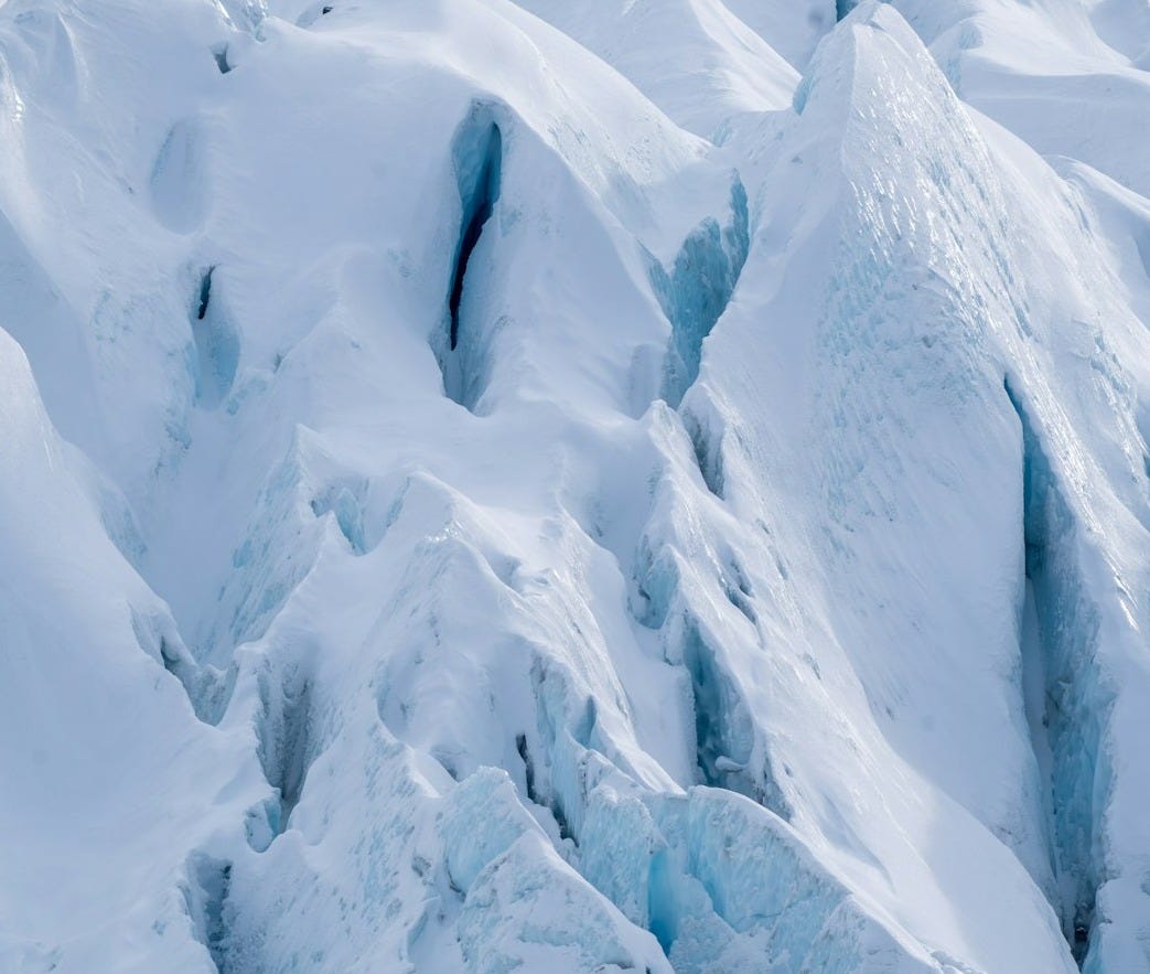 A person on skis is standing on a snowy mountain A person on skis is standing on a snowy mountain