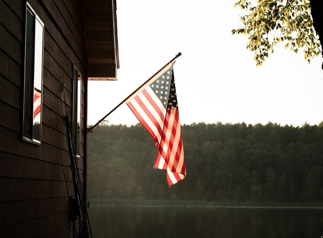 us a flag on white wooden house