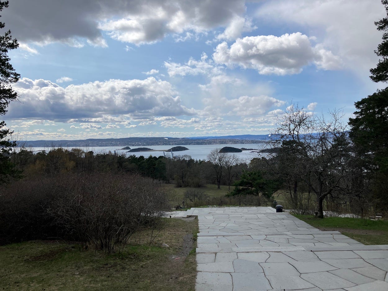 A crazy-paved broad set of steps look over another view of the bay