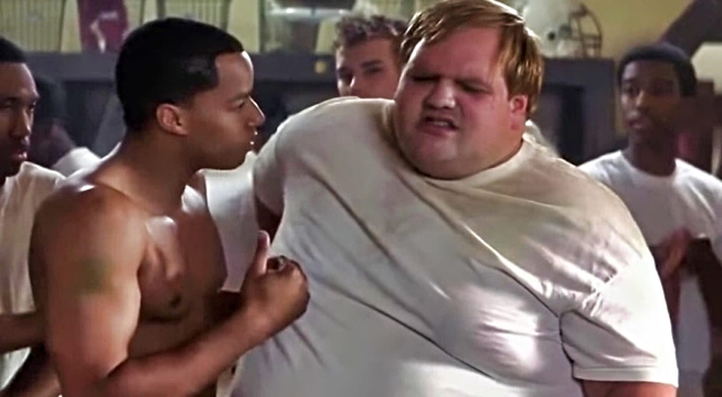 The image is a screengrab from the movie Remember the Titans showing a younger Ethan Suplee when we was extremely obese. 