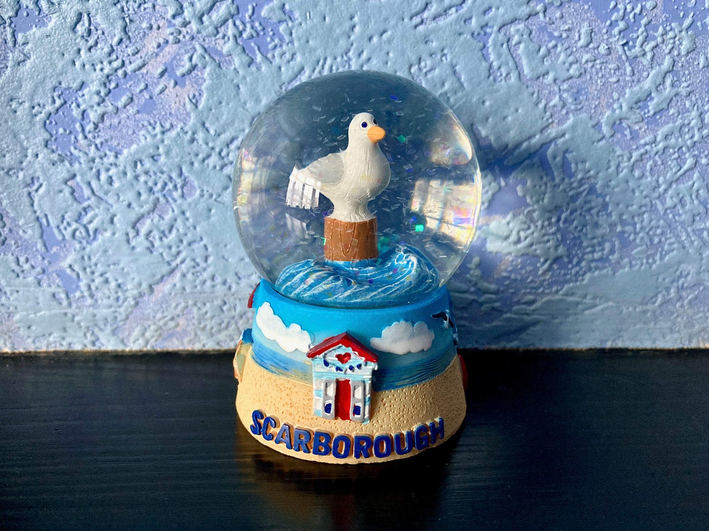 A seagull snowglobe that says 'Scarborough' on the front