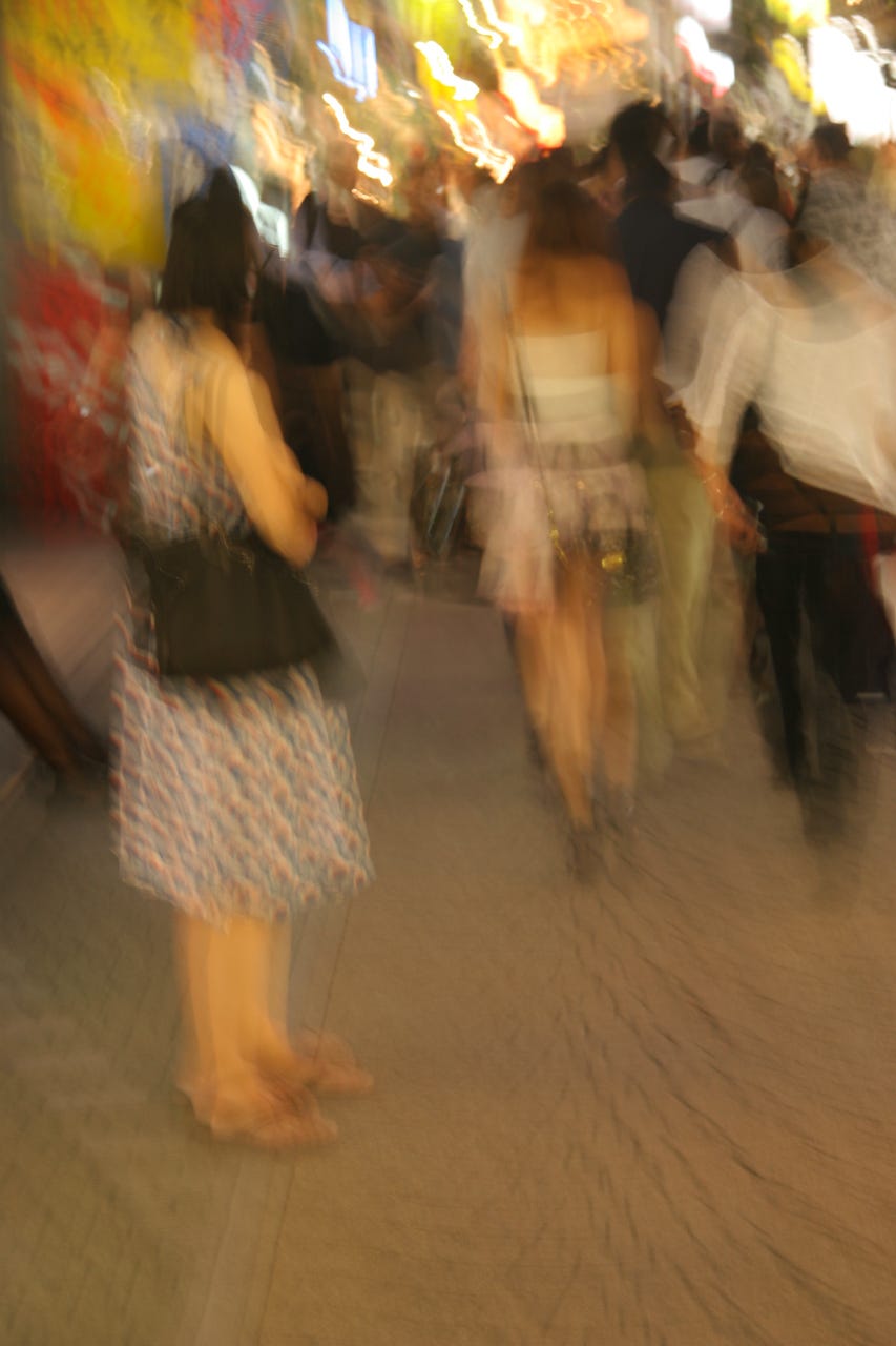 A blurry image of people walking

Description automatically generated
