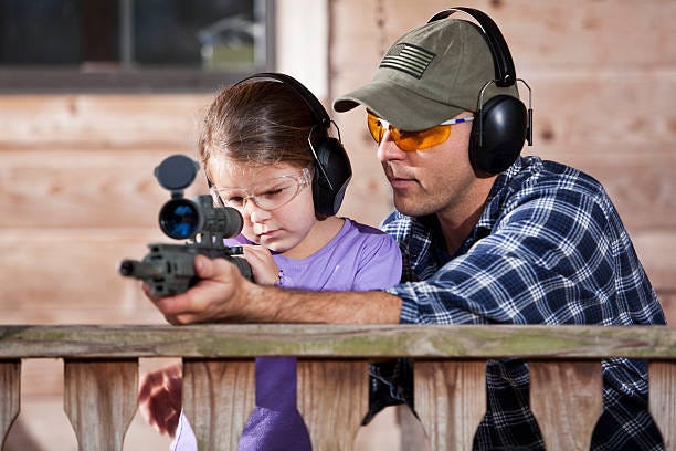 dad daughter gun ear protection eye protection optic