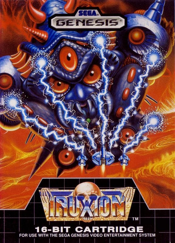A scan of the box art for the Genesis port of Truxton, which features the signature blue laser firing into a huge enemy creature slash ship that takes up most of the box and dwarfs your own ship.