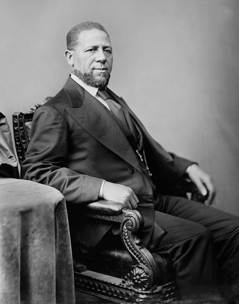 Black-and-white portrait of Revels sitting and facing right