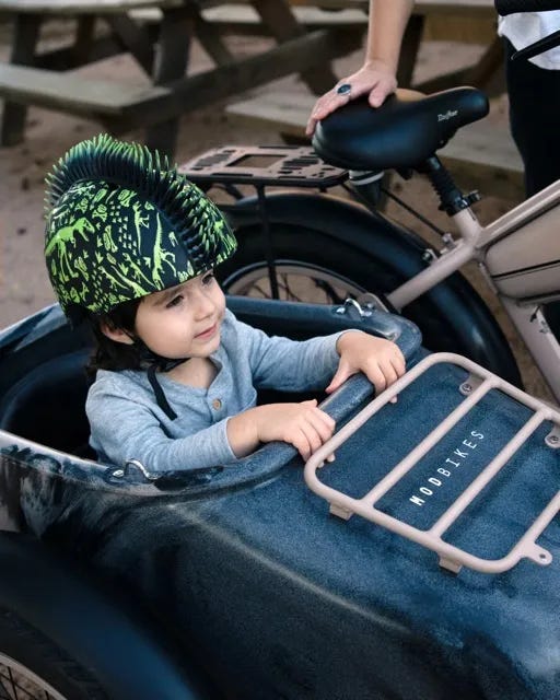 A young passenger in the sidecar on the MOD Easy SideCar 3 electric bike. 