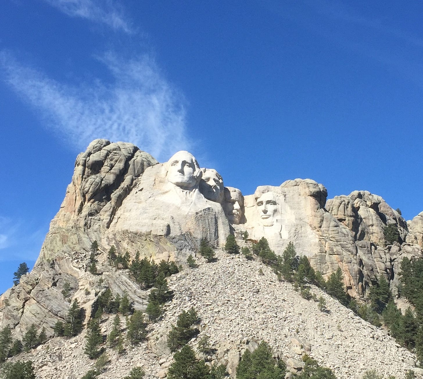 A group of stone faces on Mount Rushmore National Memorial

AI-generated content may be incorrect.