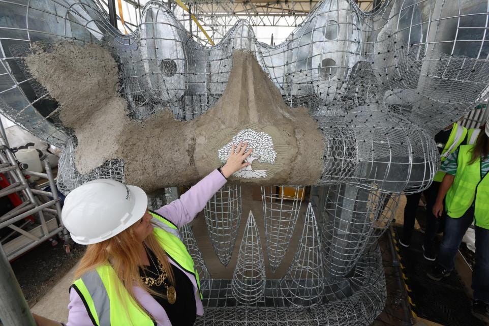 Lord Provost touches snake head sculpture.