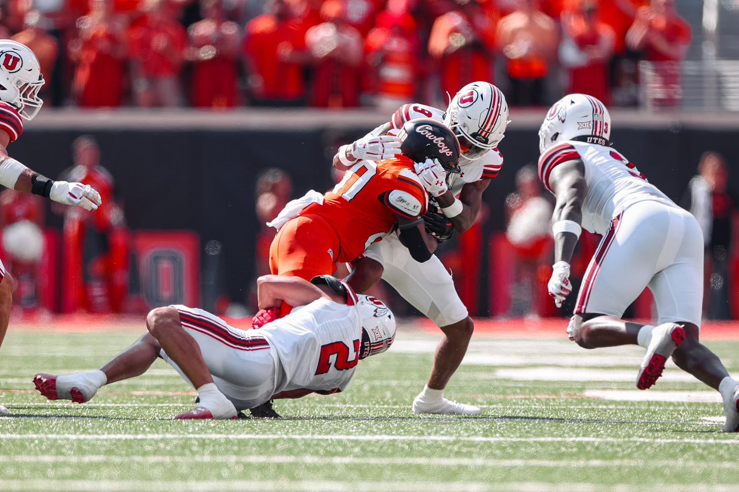 Photo of Oklahoma State receiver Brennan Presley being tackled by Utah defenders