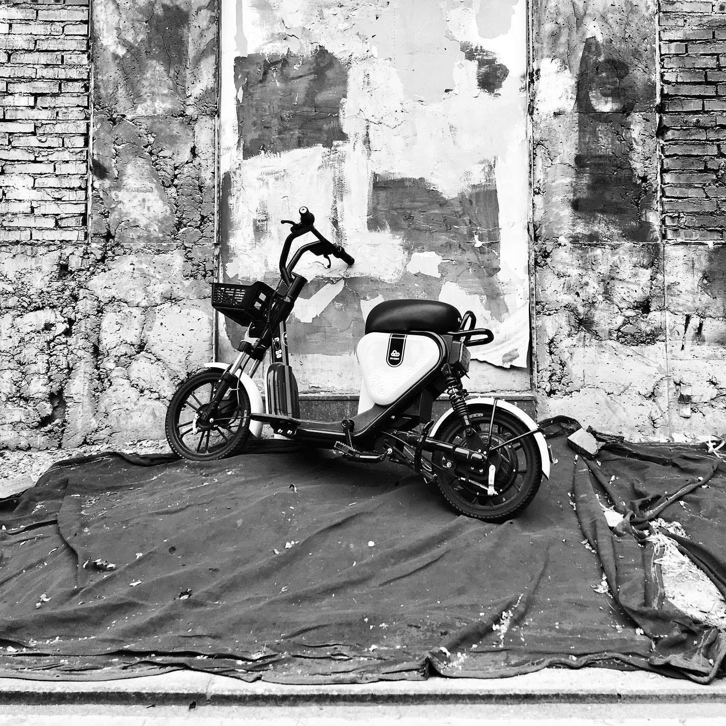 An electric scooter parked atop a pile of rubble during hutong renovations in Beijing.