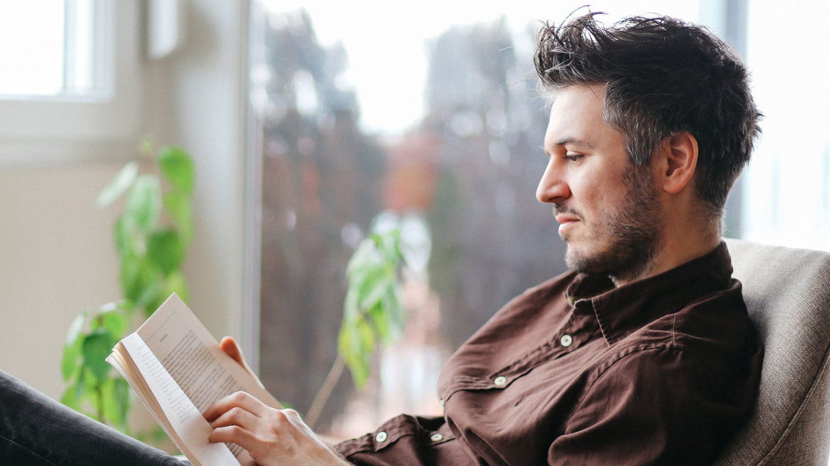 man reading a book self care gifts