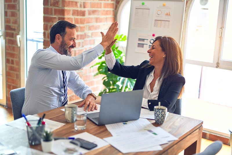 ‘Effortless: Make It Easier to Do What Matters Most’ by Greg McKeown. How to be more productive at work. Office workers high-five near a laptop. Because nothing says success like smug people high-fiving each other. A boss tried to high-five me once. That’s when I knew I had to leave.