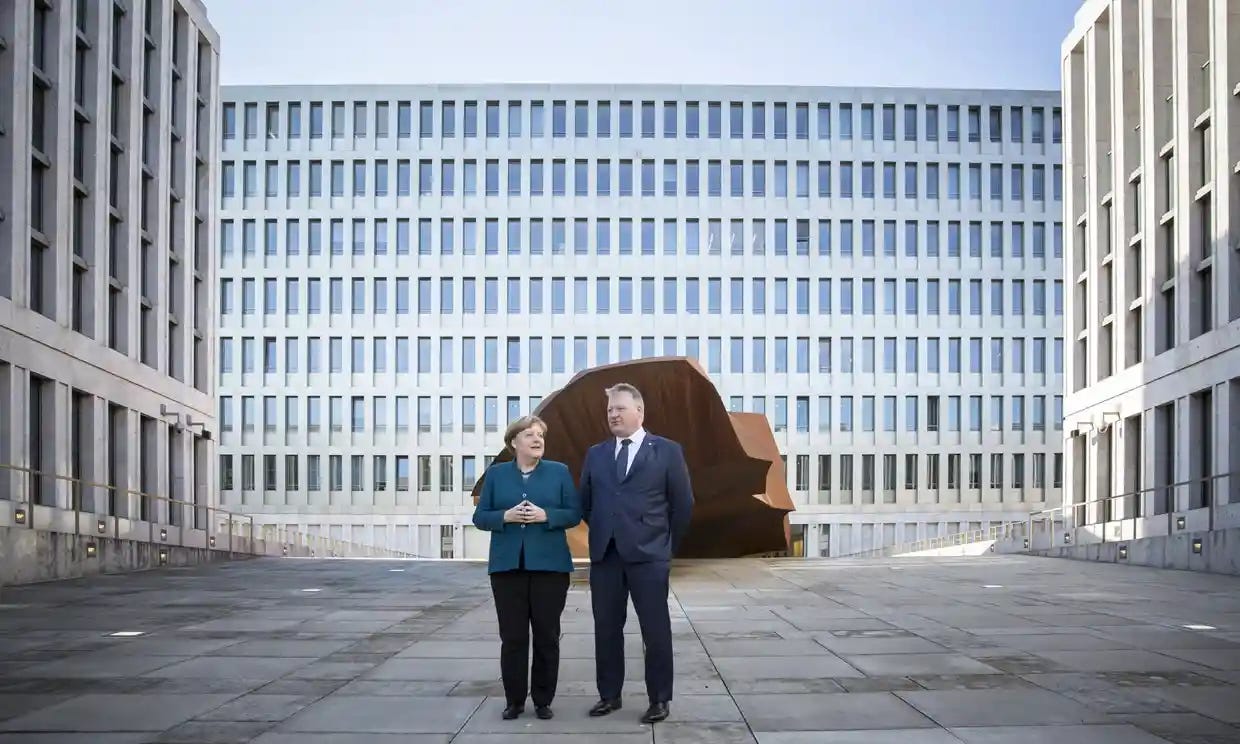 Angela Merkel and Bruno Kahl, the president of the BND, before the opening ceremony on Friday. The building has 14,000 windows and 12,000 doors. Photograph: Florian Gaertner/Photothek via Getty Images