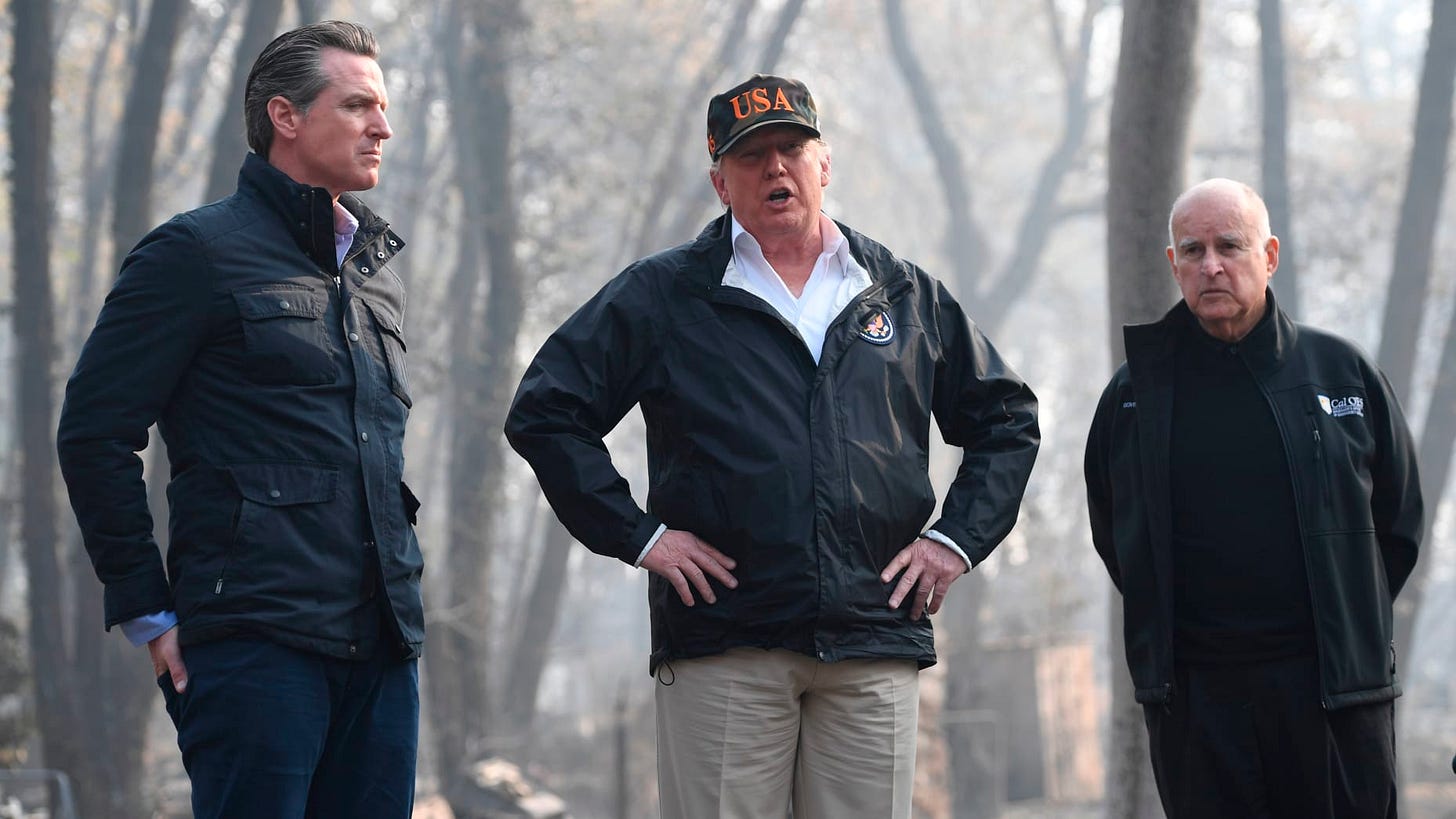 US President Donald Trump (C) looks on with Governor of California Jerry Brown (R) and Lieutenant Governor of California, Gavin Newsom, as they view damage from wildfires in Paradise, California on November 17, 2018.