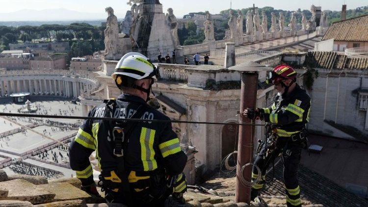 Workers install the chimney on top of the Sistine Chapel in the Vatican