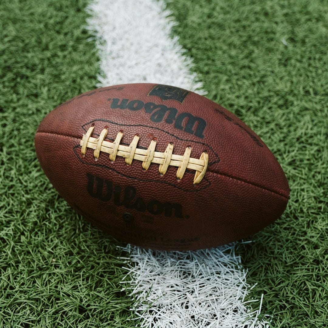 brown Wilson American football on grass brown Wilson American football on grass