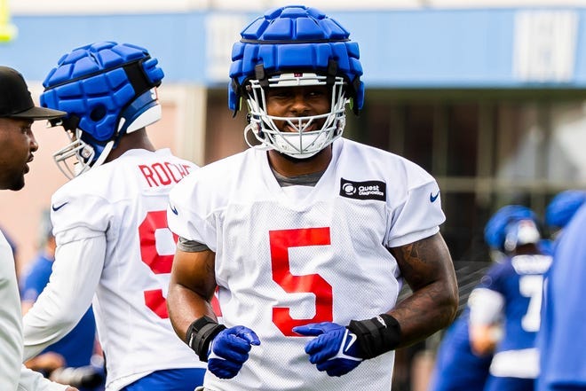 New York Giants linebacker Kayvon Thibodeaux takes part in drills while wearing an NFL-mandated Guardian Cap.