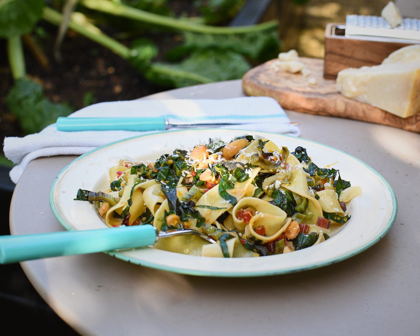 Rainbow Chard, Orange and Almond Pappardelle on a table in the garden